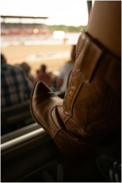 Stylish cowboy boots captured at a lively rodeo ev