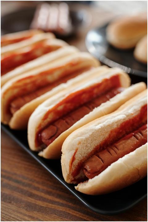 Appetizing hot dogs lined up with ketchup, perfect