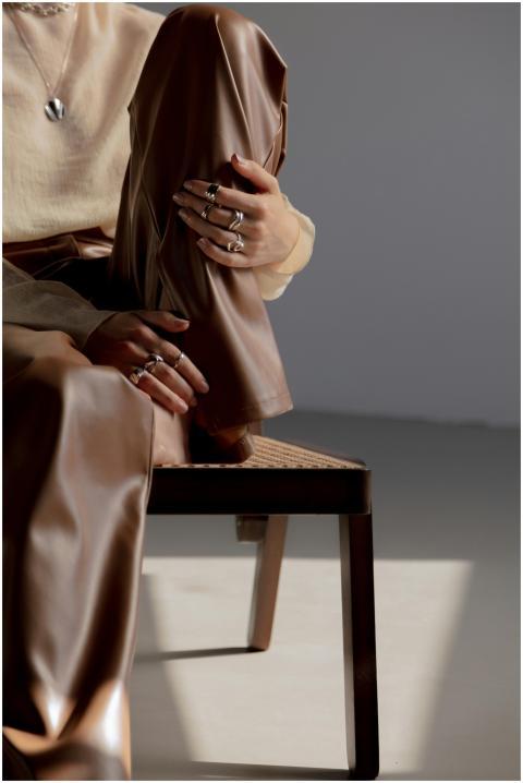 Fashionable outfit with elegant rings, showcasing