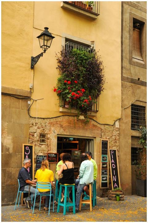 Group enjoying drinks at a quaint café on a pictur