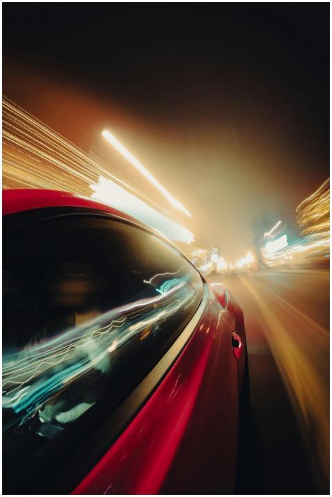 Vibrant car lights streak through the night, captu