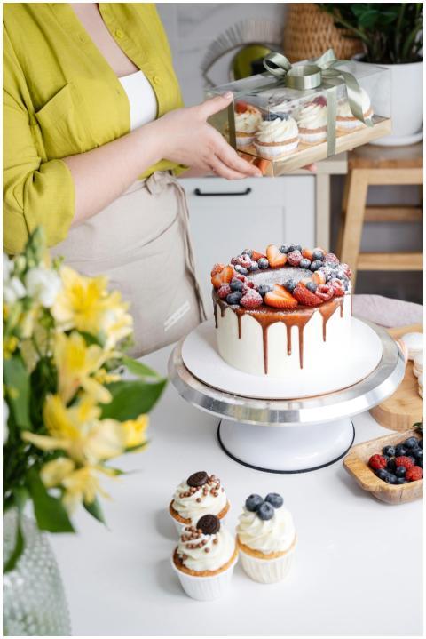 Crop unrecognizable female confectioner with delic