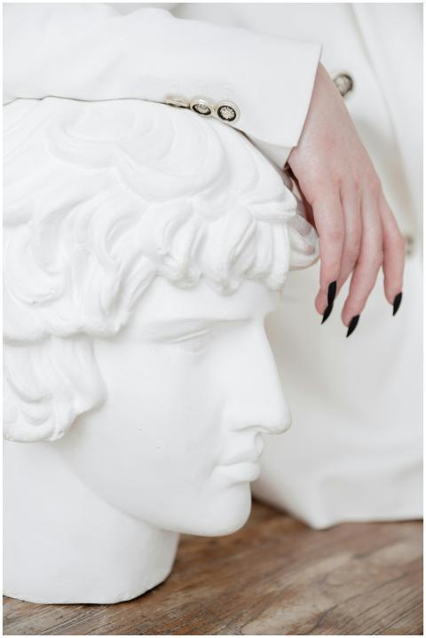 Close-up of a hand with manicured nails resting on