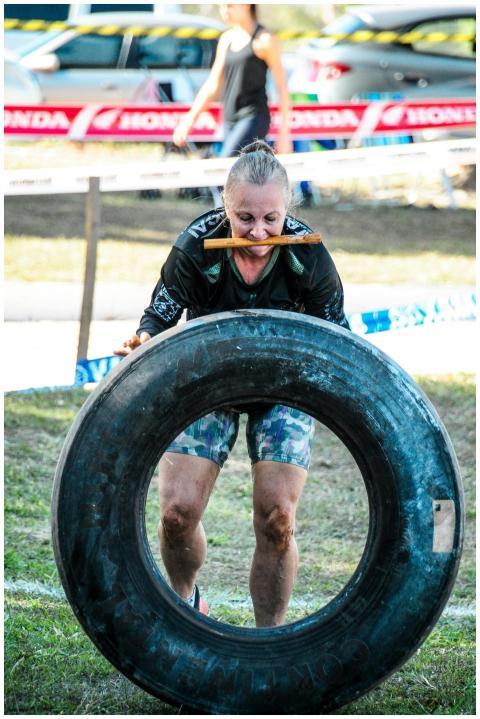 Woman participating in a tire flipping challenge o