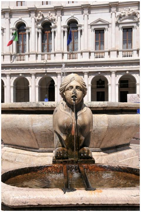 Beautiful fountain sculpture in front of historic