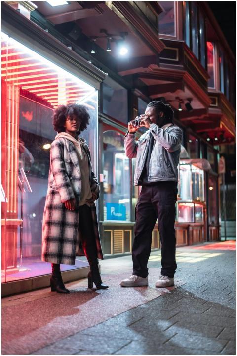 Stylish couple exploring urban nightlife, capturin