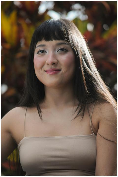 Portrait of a smiling woman outdoors against a vib