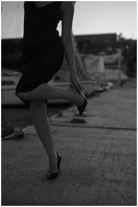 Black and white photo of a stylish woman in high h