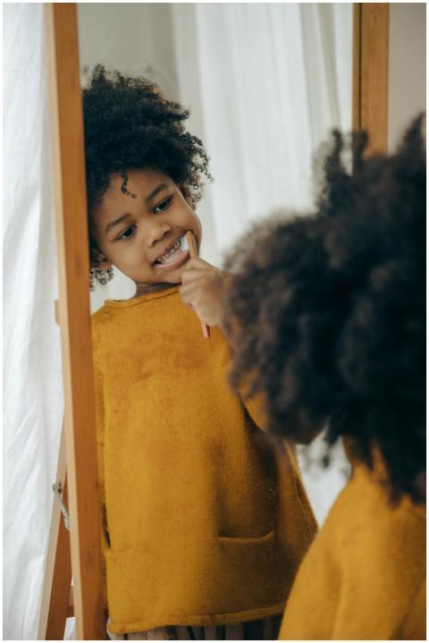 Concentrated black child in yellow sweater cleanin