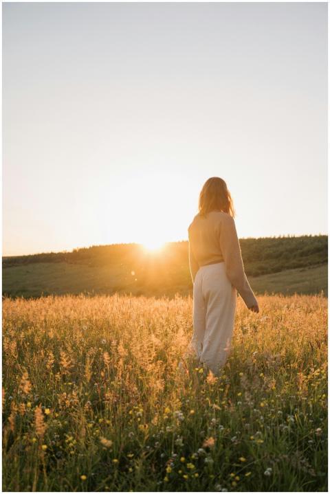 A tranquil moment of a woman in a summer meadow at