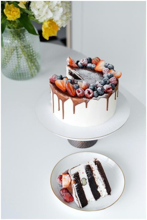Enjoy a gourmet chocolate drip cake topped with fr