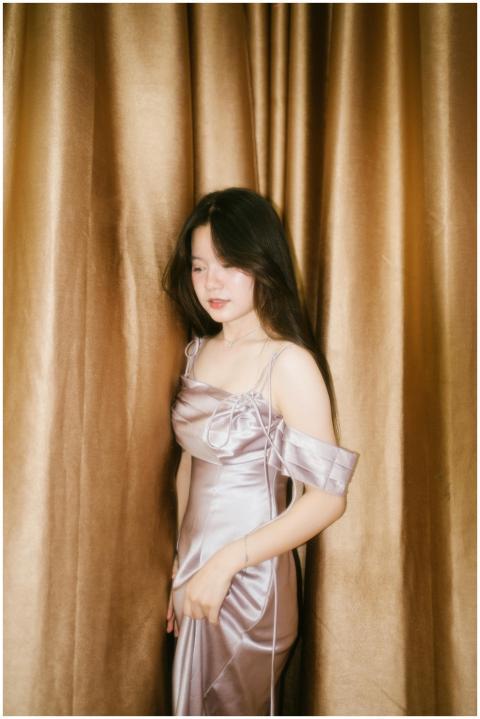 A serene portrait of a woman in a satin gown set a