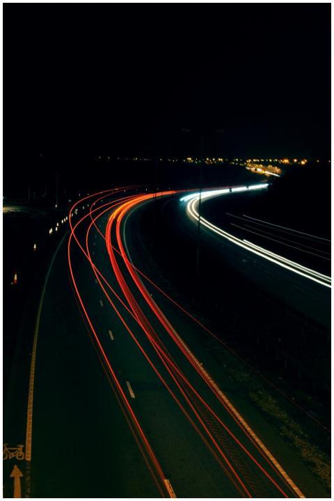 Long exposure photo capturing light trails on a hi