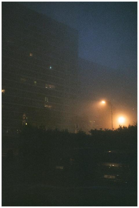 Moody nighttime urban scene with fog and illuminat