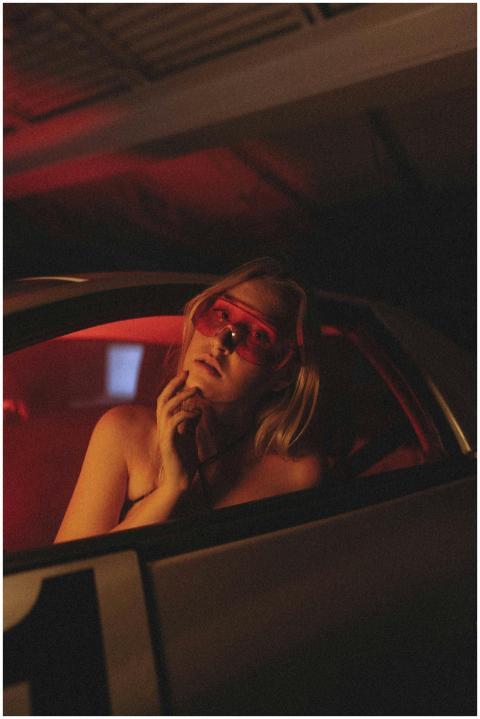 Stylish portrait of a woman wearing red sunglasses