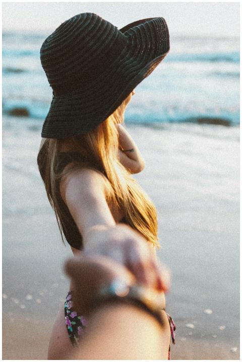 Couple holding hands on a serene beach, capturing