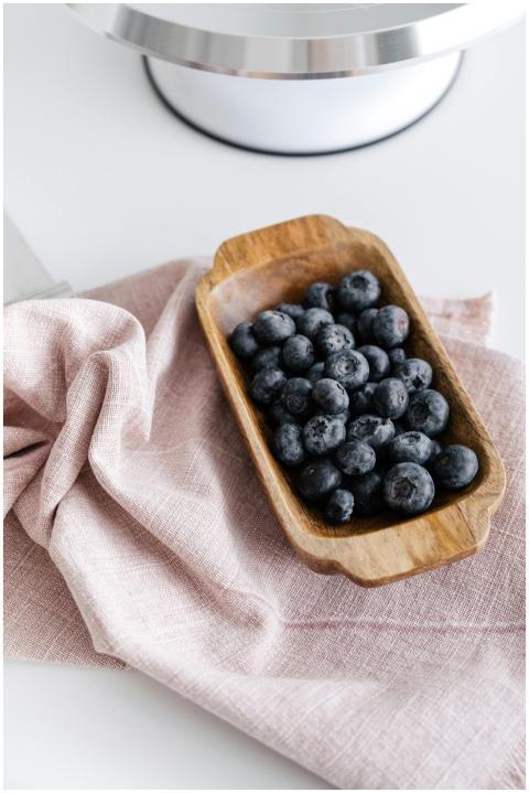 From above of wooden bowl with ripe delicious blue
