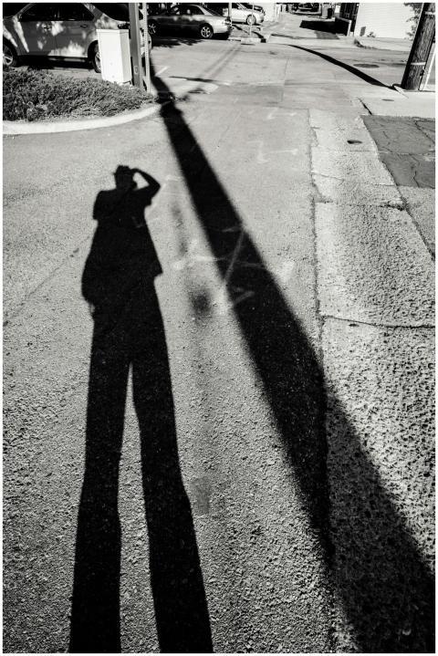 Monochrome shot capturing a shadow on a city stree