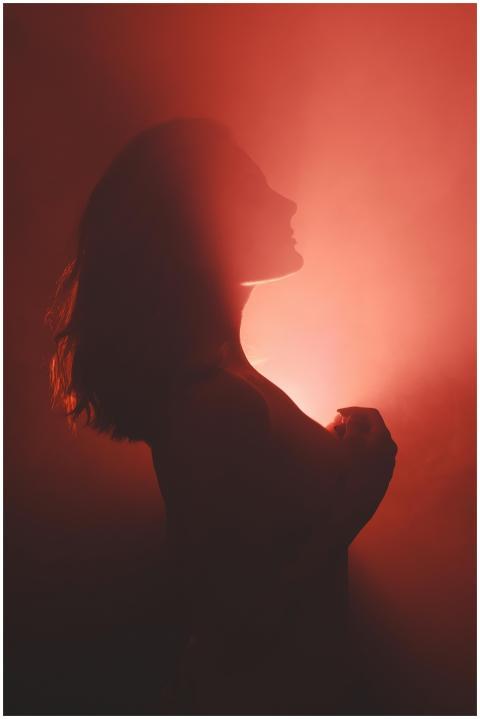 Artistic silhouette of a woman against a dramatic
