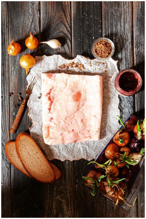Top view of salo, vegetables, and bread on a rusti