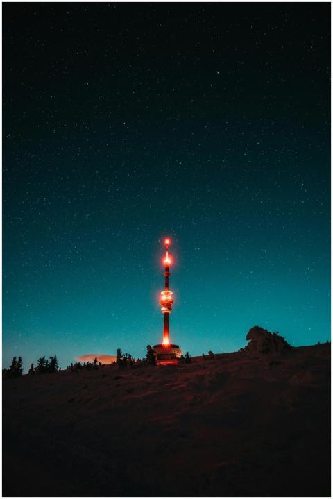 Illuminated tower under a starry sky in Malá Moráv