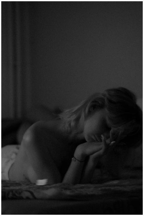 Artistic black and white portrait of a woman lying