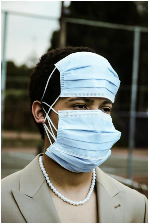 A creative portrait of a person wearing multiple m