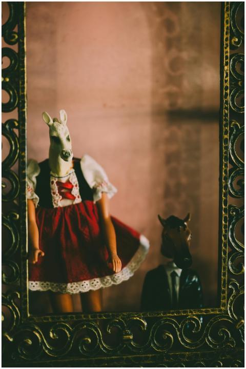 Quirky dolls in horse masks dressed in traditional