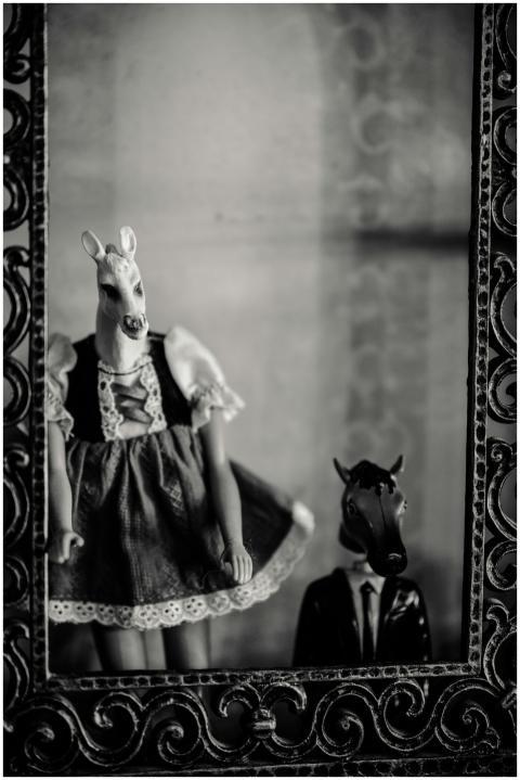 Black and white photo of figurines in animal masks