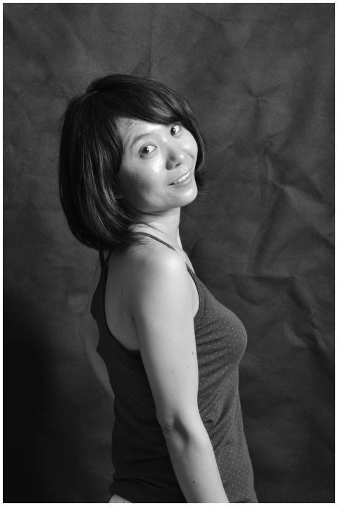 Artistic black and white portrait of a smiling wom