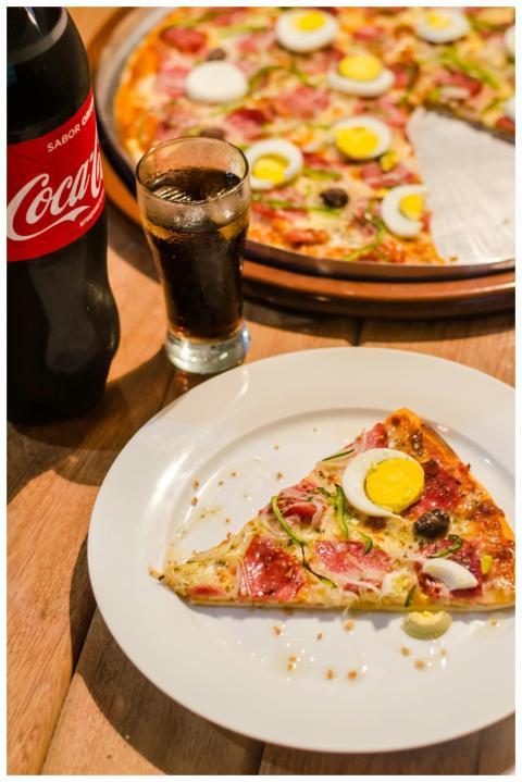 Delicious pizza with eggs and olives, paired with
