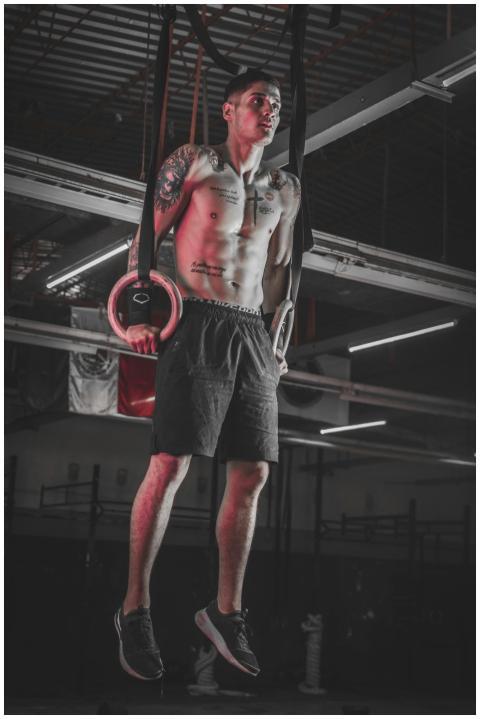 Athlete performing strength training on rings indo