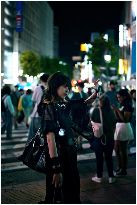 A fashionable woman stands in Shibuya, Tokyo, amid