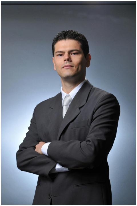Confident businessman wearing a gray suit with cro