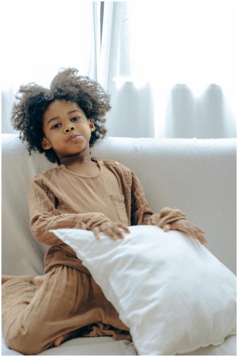 A young child in pajamas enjoying a relaxed moment
