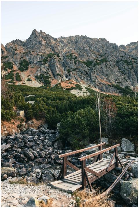 Wooden footbridge over rocky brook with stunning m