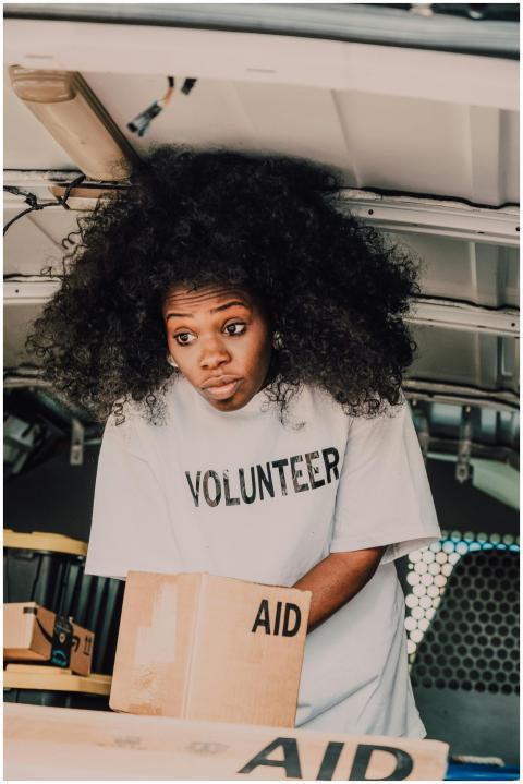 A dedicated volunteer sorting aid boxes, bringing