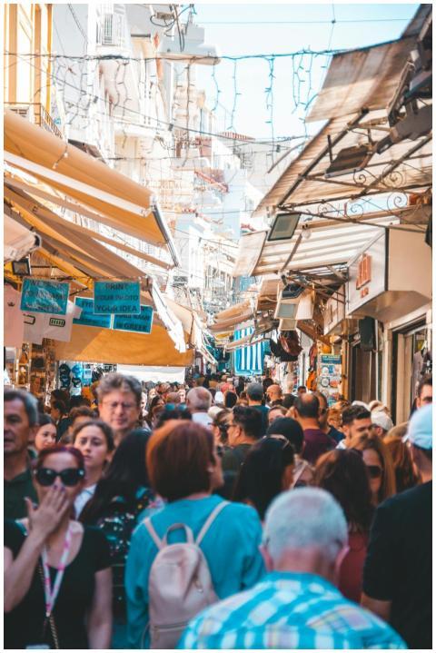 Bustling street market in Athens with diverse crow