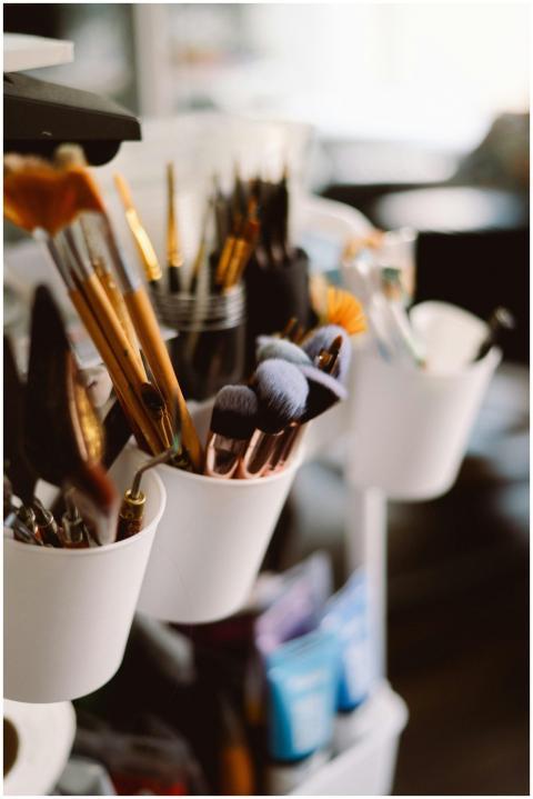 A variety of paintbrushes and art supplies organiz