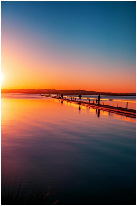 A breathtaking sunset view over a tranquil boardwa