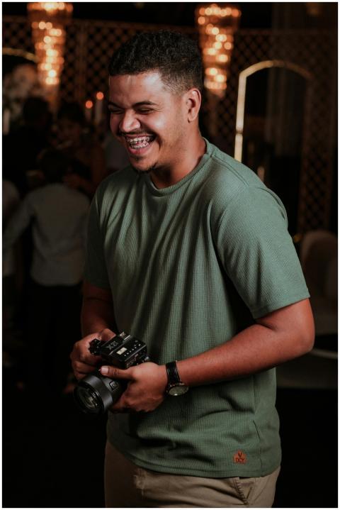 Joyful photographer with a camera at a festive ind