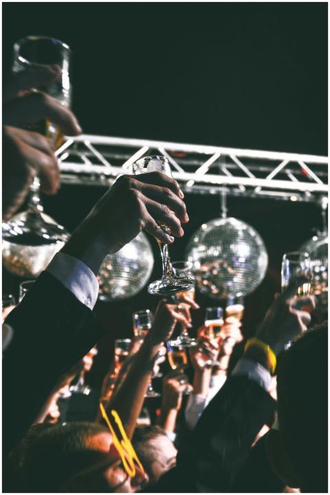 A festive gathering with people raising glasses in