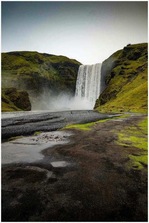 Breathtaking view of Skógafoss waterfall surrounde