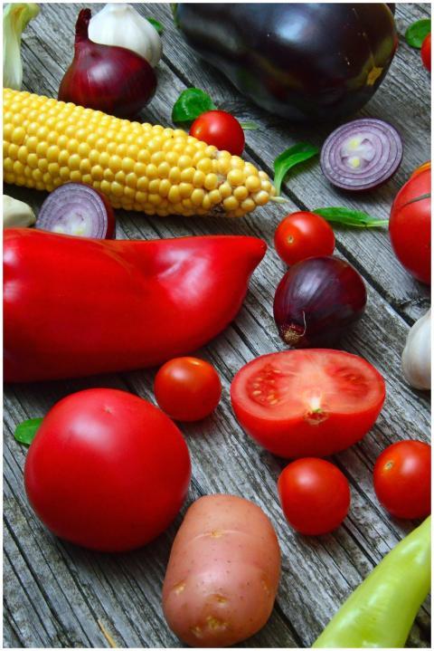 A vibrant assortment of fresh vegetables on a rust