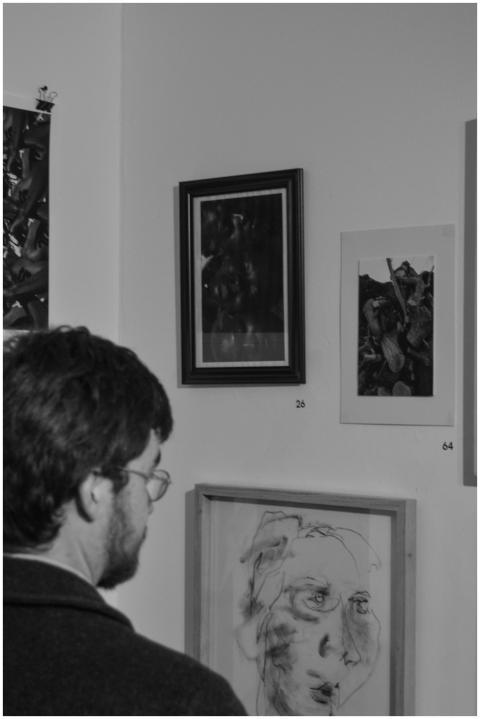 Man admiring framed artwork in a Cape Town gallery