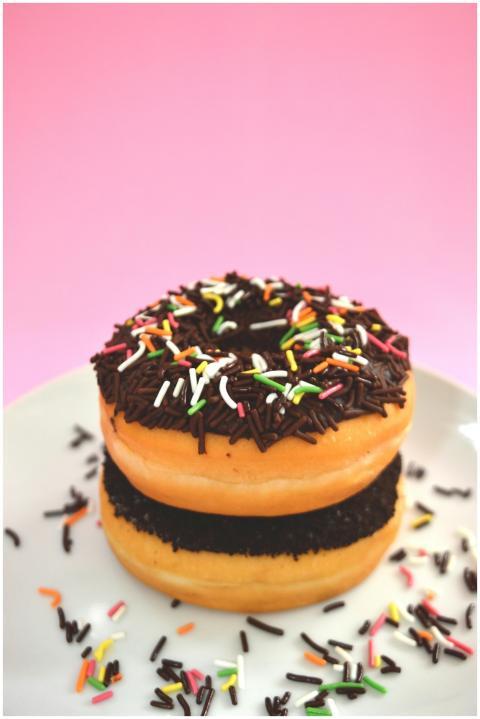 Stacked doughnuts with chocolate and colorful spri
