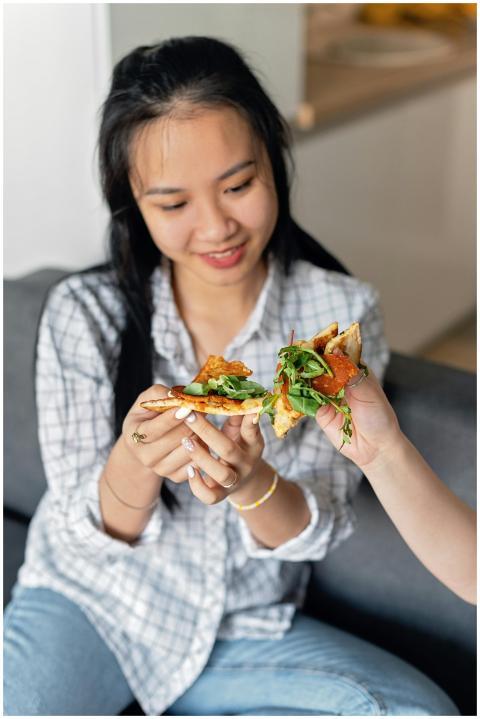 Young woman smiling while enjoying a slice of arug