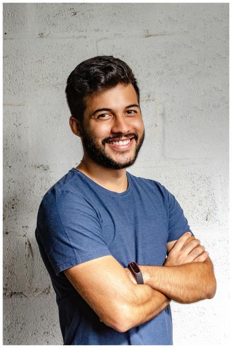 Portrait of a happy man with arms crossed, exuding