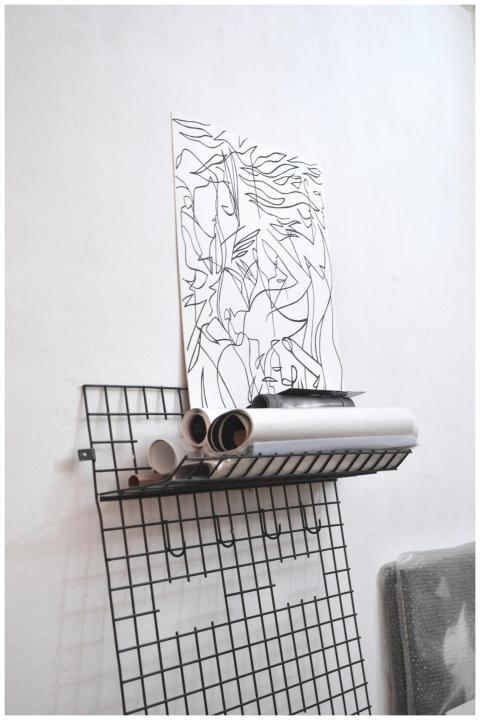 Stylish wire shelf featuring minimalist line art a