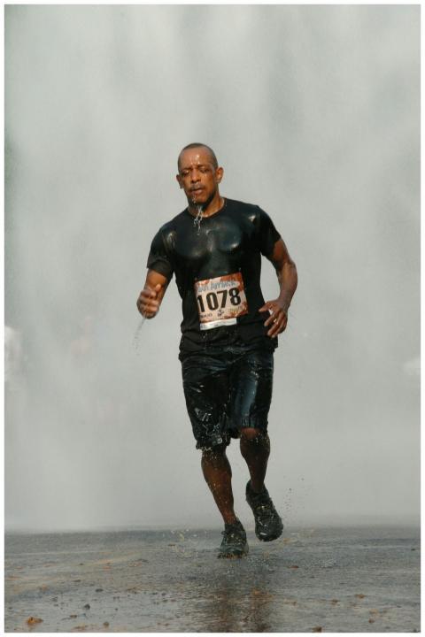 Man participating in a marathon running through a